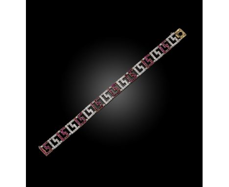 A French ruby and diamond bracelet, set with calibre-cut rubies and diamond in Greek key pattern design in platinum and gold,