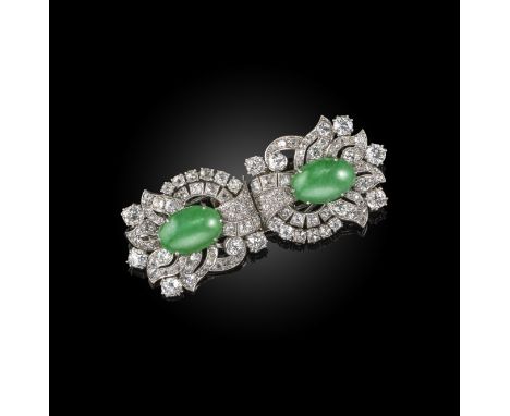 A mid 20th century jade and diamond double clip brooch, each clip set with an oval jade cabochon within scrolling foliate sur