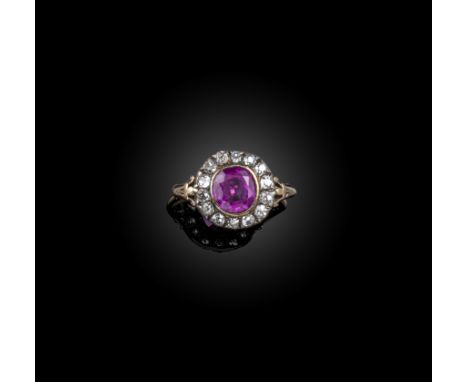 A late 19th century ruby and diamond cluster ring, the ruby weighing approximately 2.75cts, set within a surround of old cush