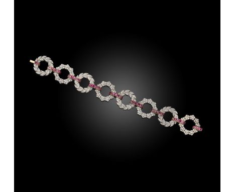 A French early 20th century ruby and diamond bracelet, designed as alternating platinum laurel wreaths set with diamonds join