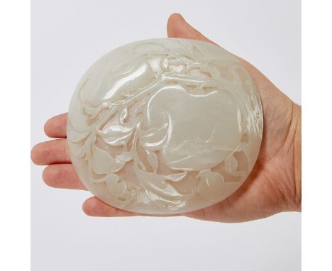 Chinese round plaque or dish carved of a lovely pale jade depicting peaches and bats.Height: 5 1/4 in x width: 4 1/2 in.