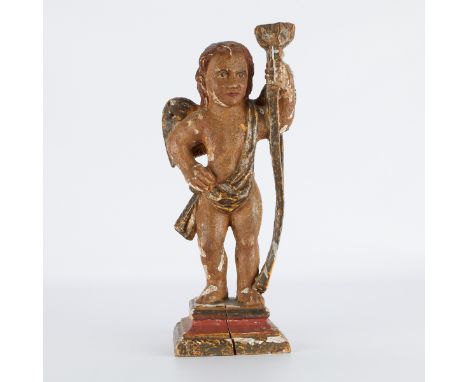 18th century Continental polychromed wooden candlestick in the form of a winged cherub draped in a cloth.Provenance: From the