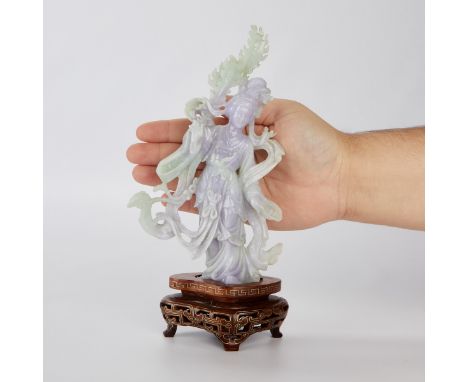 Chinese Republic carved lavender jade depicting a guanyin in flowing robes. With a carved wooden stand.Without the stand; hei