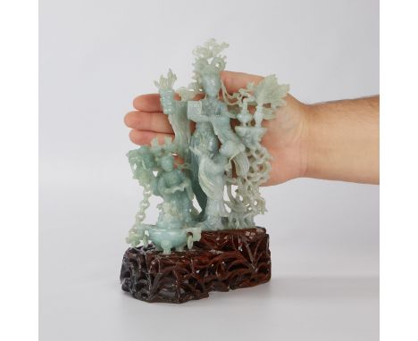 Chinese Republic elaborately carved jade depicting maiden holding paint brushes and scholar's objects. Two small children sta