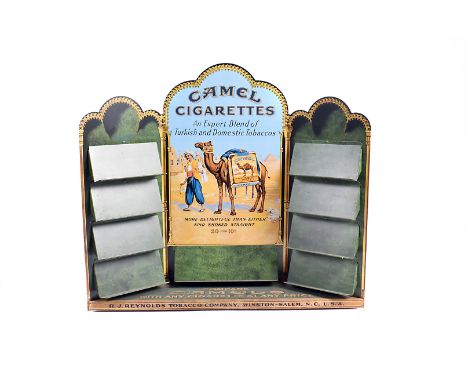 A tinplate Camel Cigarette counter top display, with central shelf below Middle Eastern design, and four small shelves to eit