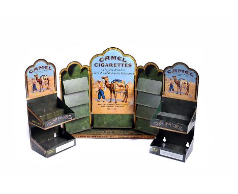 A tinplate Camel Cigarette counter top display, with central shelf below Middle Eastern design, and four small shelves to eit