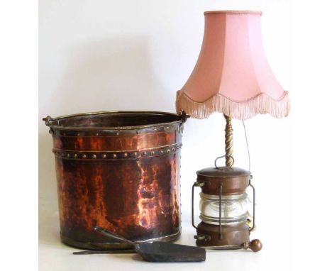 Circular beaten copper coal/log bucket with brass swing handle, small copper ships style lantern and barley-twist brass lamp.
