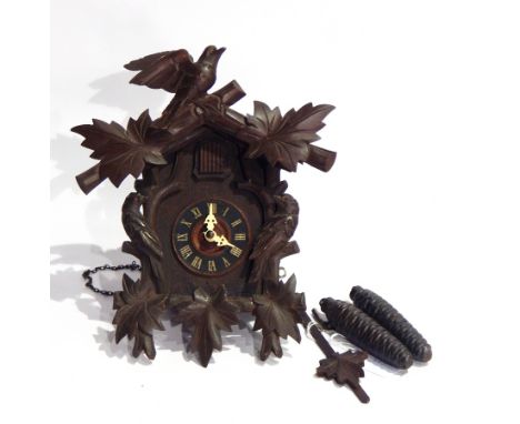 Black Forest cuckoo clock with carved bird surround 