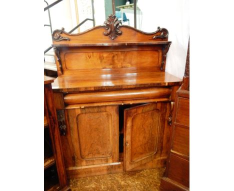A Victorian rosewood chiffonier with a shelf back, cushion frieze drawer with a pair of panelled cupboard doors below enclosi