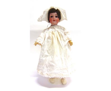 AN ARMAND MARSEILLE BISQUE SOCKET HEAD DOLL  with a cropped light brown wig, sleeping grey glass eyes, and an open mouth with