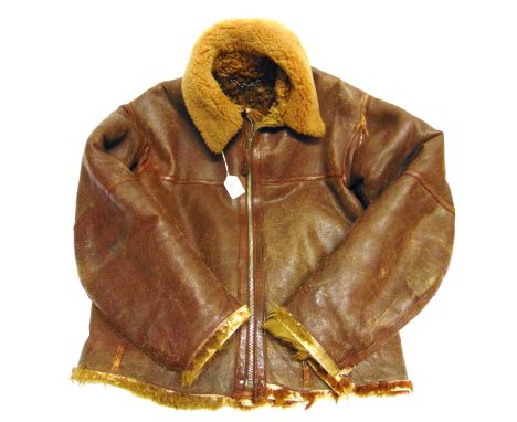 A BRITISH R.A.F. IRVIN STYLE PANELLED BROWN LEATHER FLYING JACKET  with a short-pile sheepskin collar and a long-pile sheepsk