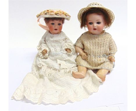 TWO BISQUE DOLLS  comprising a bisque socket head doll, probably by Otto Reinecke, with a cropped brown wig, sleeping grey gl