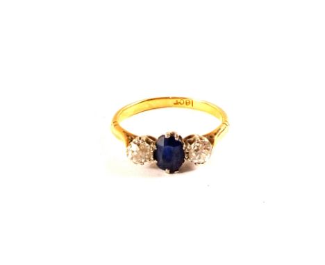 A Sapphire and Diamond three stone ring in 18ct Gold, size K