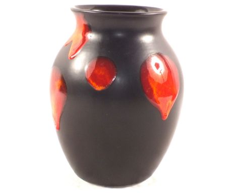 A Poole black ground vase with red and orange roundels