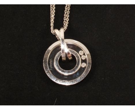 A Chopard 18ct White Gold 'happy Diamonds' pendant in the form of a circle within a circle with three floating Diamonds inbet