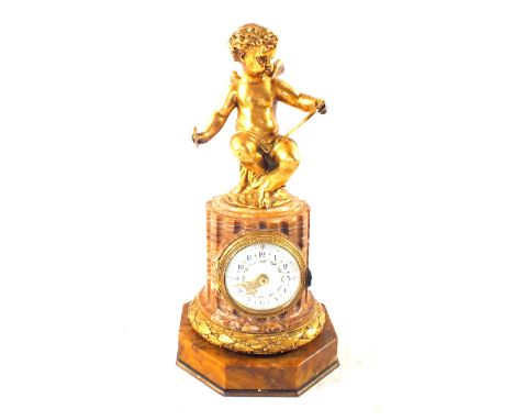 A Bellman, Ivy and Carter gilt metal and rouge marble clock with cherub mount