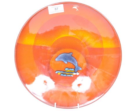 A contemporary Poole Pottery Final Quay Edition charger plate having a red and orange background with a central panel of a ju