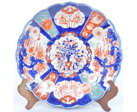 A large early 20th century Meiji Japanese Imari charge plate / bowl having hand painted florals upon a cobalt base with a cen