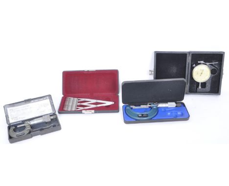 A collection of four mid 20th century engineers measuring tools to include the manufacturers Moore &amp; Wright micrometer, a