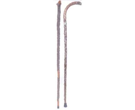 A pair of early 20th century blackthorn walking sticks. To include a knob stick walking stick with carved handle in the form 