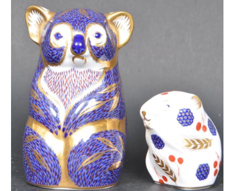 A contemporary Royal Crown Derby koala ceramic paperweights having a blue background with gilt detailing. Gold stopper to the