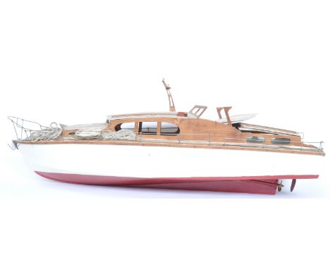 A vintage 20th century circa 1960s wooden remote control speedboat hull having wire fencing to the edge and detachable cover 