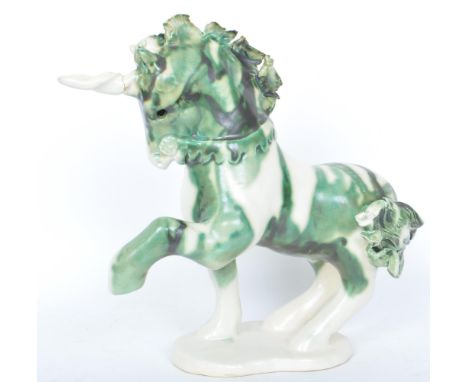 A vintage 20th century Paula Humphries Polperro of Cornwall studio art pottery figurine of a unicorn raised on a oval base. M