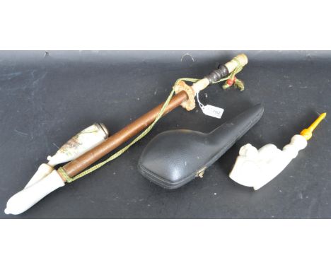 A vintage mid 20th century resin pipe having an ornate bowl and shank decorated with a dog and a faux amber stem. Come with i
