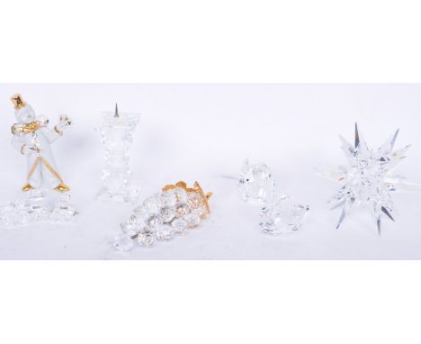 A collection of contemporary Swarovski glass items comprising of large star, train, tender (retires piece), candlestick, grap