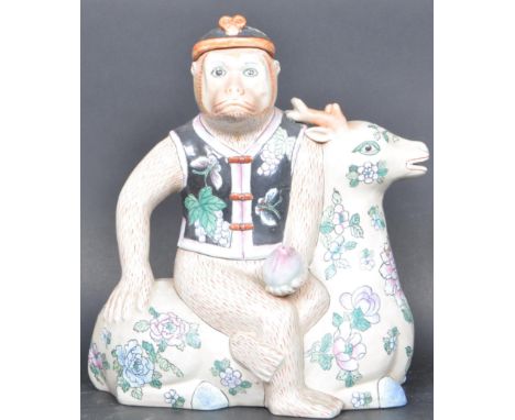 A 20th century Chinese Oriental ceramic teapot in the shape of a monkey holding a peach seated on a deer. The teapot has poly