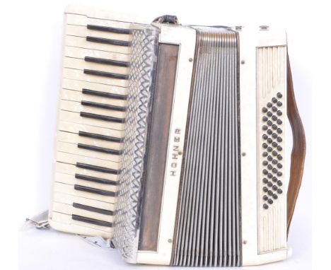A vintage 20th century Hohner accordion musical instrument having faux tortoiseshell detailing with arm straps to the front. 