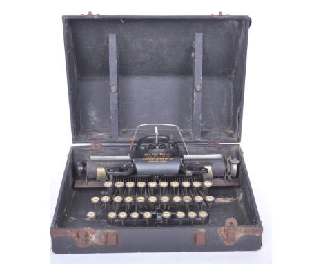 A vintage 20th century Baby Rem / Remington typewriter having an ebonised frame with gilt detailing. Comes with a hard carry 