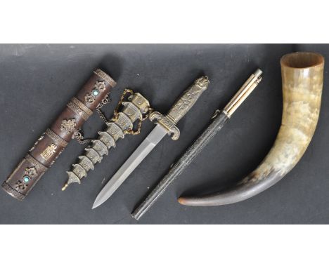 A Chinese bone and pictorial knife set in scabbard together with an ox horn, metal dagger and scabbard and a metal relief cas