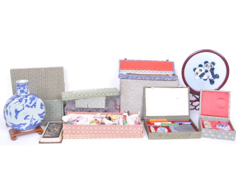 A collection of boxed 20th century Chinese presentational items to include pottery nodding children, wooden dream screen, min