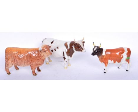 A group of three late 20th century vintage Beswick porcelain cow figures to include an Ayrshire Bull, a highland bull and ano