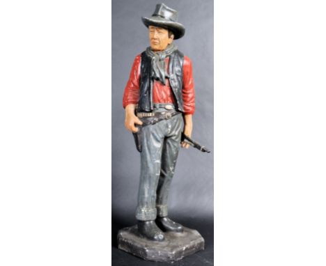 A retro vintage mid 20th Century plaster / chalk advertising figurine depicting John Wayne. The floor standing figure having 