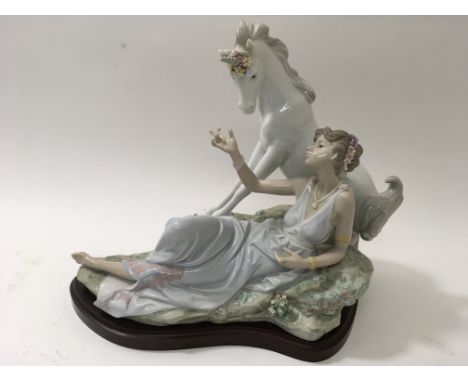 A large Lladro 'Goddess and the Unicorn' model, presented on wooden plinth.Approximately 35x29cm high
