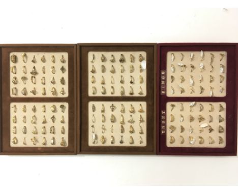 Three trays of unmarked yellow metal sampler rings.