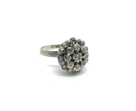 An 18ct white gold flower head ring inset with diamonds, ring size approximately K/L total weight approximately 4 grams.