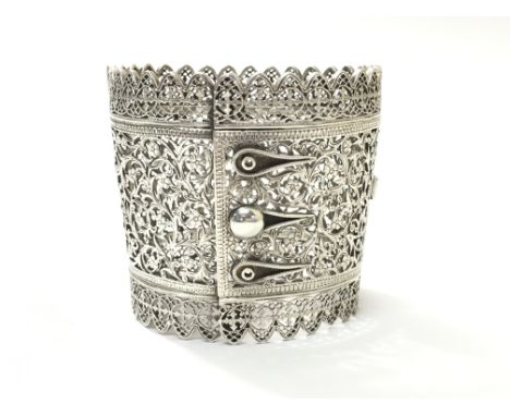 A large pierced silver bangle with floral design, approximately 77 grams.