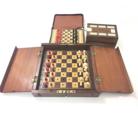 Two travelling chess sets, one probably turned and painted ivory and a cribbage set.