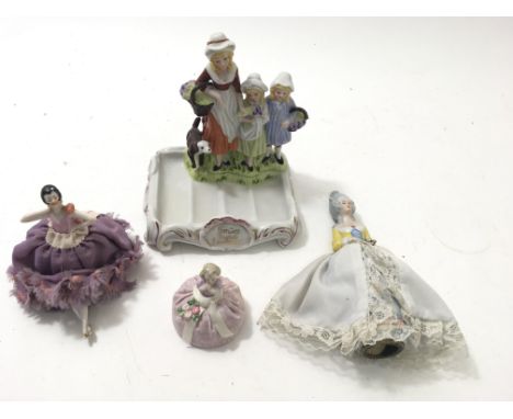 A Yardley advertising figure and three ceramic pin head dolls