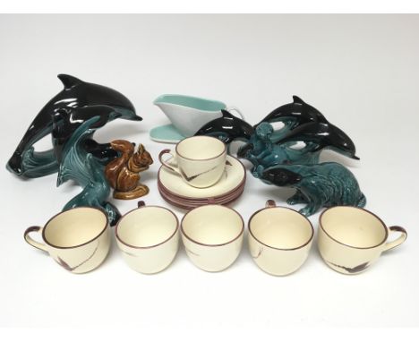 A collection of Poole pottery to include six cream and red dragonfly design cups and saucers, eight teal and black figures of