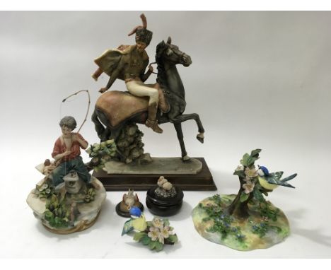 A large Capodimonte figure of a soldier on horseback signed 'Redaelli', another model of a boy fishing, a bird ornament, a/f,