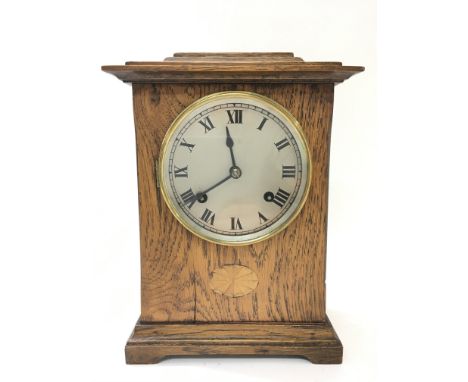 An oak mantel clock with Roman numerals, key and pendulum in office, note in the back of the clock to explain the workings of