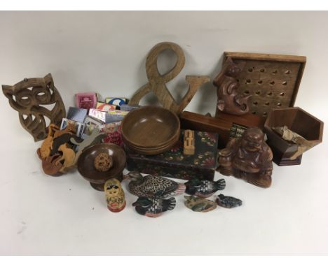 A collection of wooden items to include a Buddha, ducks and boxes as well as a large quantity of playing cards.