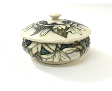 A small, boxed Moorcroft 'Juneberry' pattern lidded trinket dish, designed by Anji Davenport, dated 2000. Approximately 12cm 