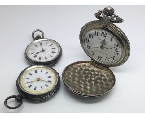 Two silver cased fob watches with enamel dials and one other pocket watch with shooting and hunting scenes on the case.