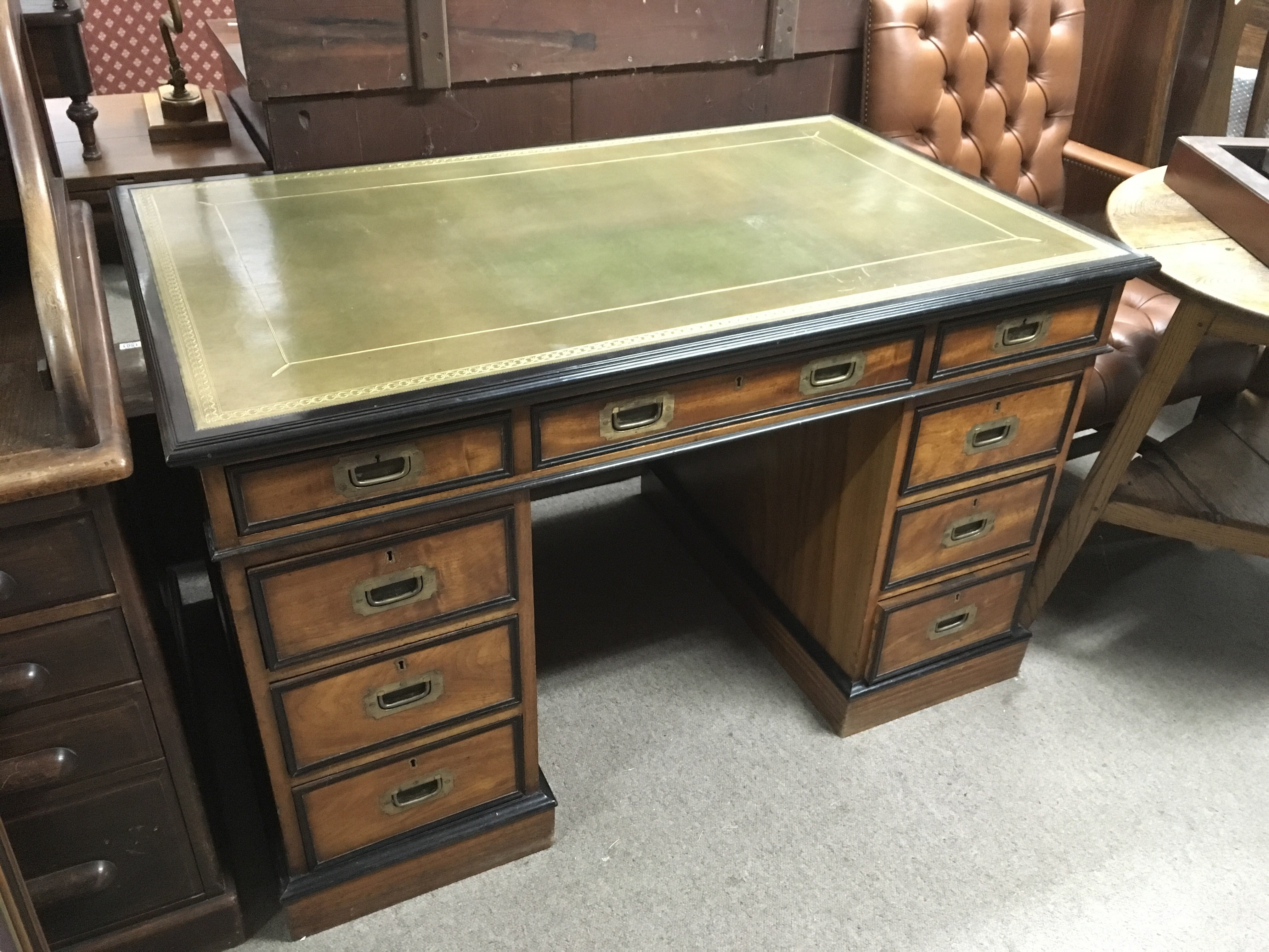 A Victorian captain's desk with inset green leather top and recessed