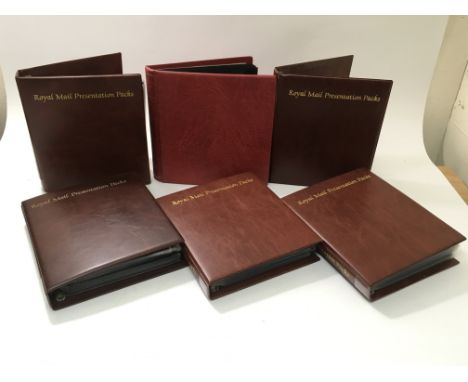 A collection of five Royal Mail Presentation packs and one other stamp album, largely containing mint stamps and first day co